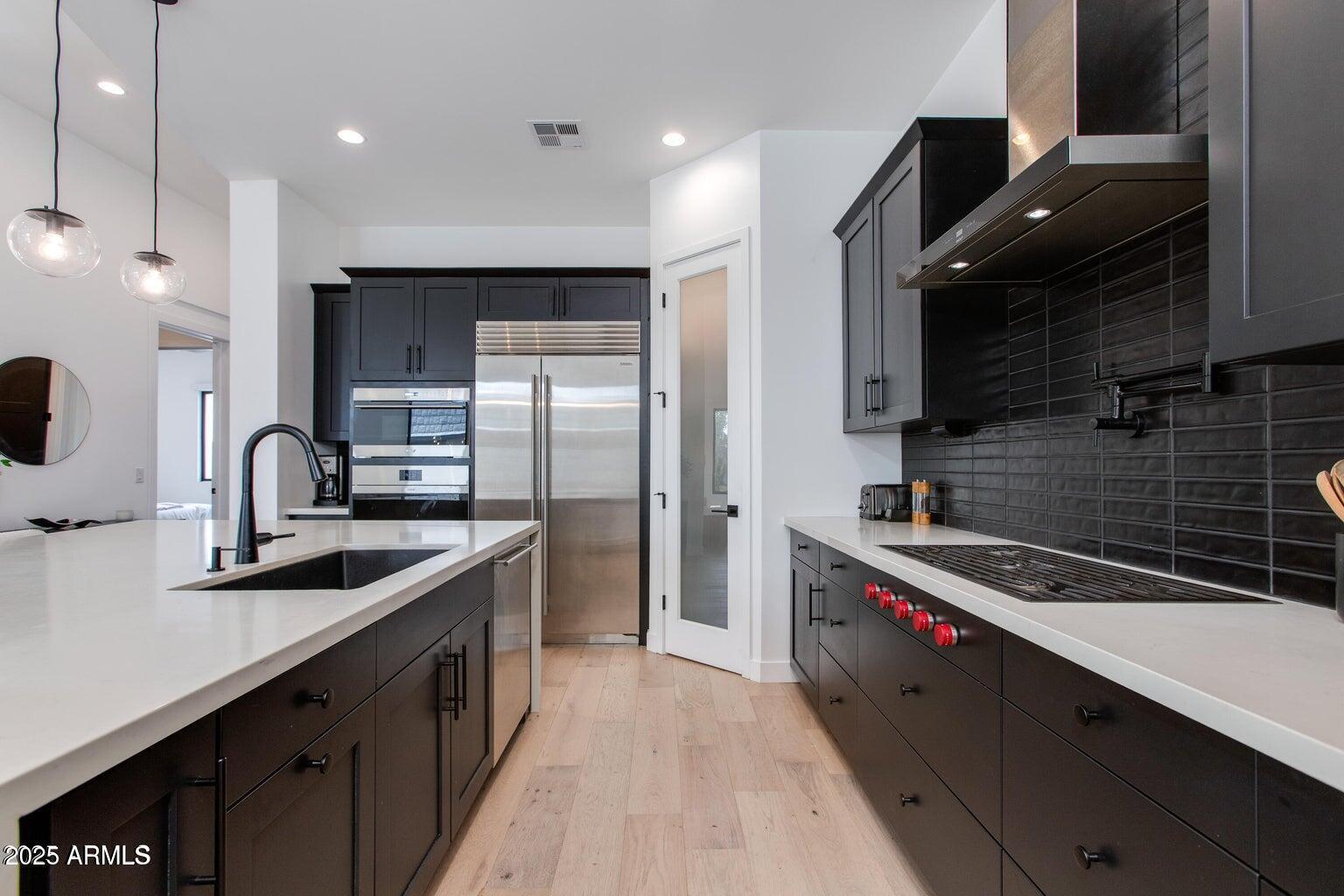 100 West Northern Avenue, Unit 17 Phoenix, AZ 85021 - Photo 9 of 20 a kitchen with kitchen island granite countertop a sink stainless steel appliances and cabinets