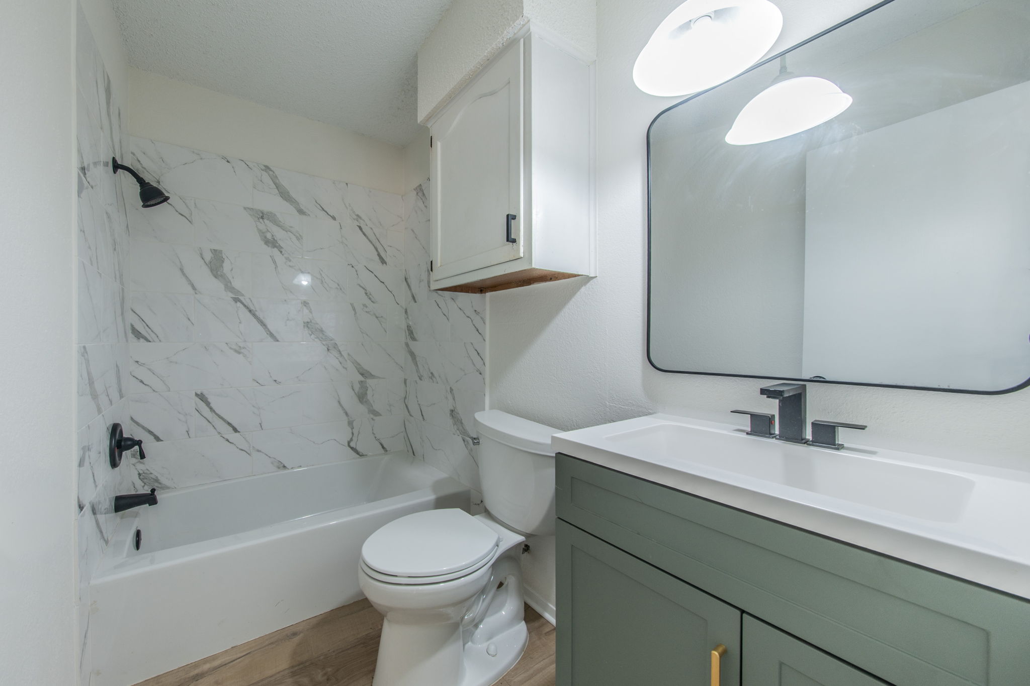 4504 Langtry Lane Austin, TX 78749 - Photo 13 of 24 A well-appointed bathroom featuring a clean, modern vanity and a classic tub with elegant tiled surround.