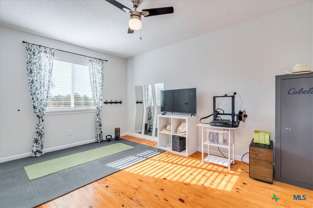 171 Pin Oak Crossing Elgin, TX 78621 - Photo 25 of 38 a living room with furniture a flat screen tv and a table