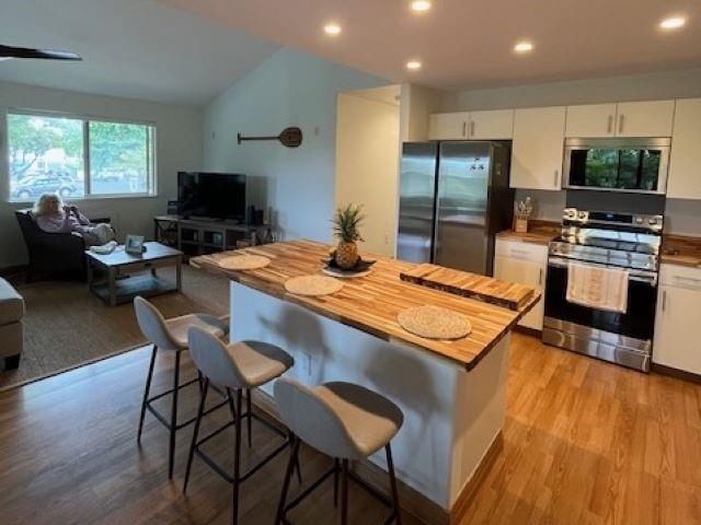 46 Polohina Lane, Unit 5 Lahaina, HI 96761 - Photo 5 of 10 a kitchen with a table and chairs in it