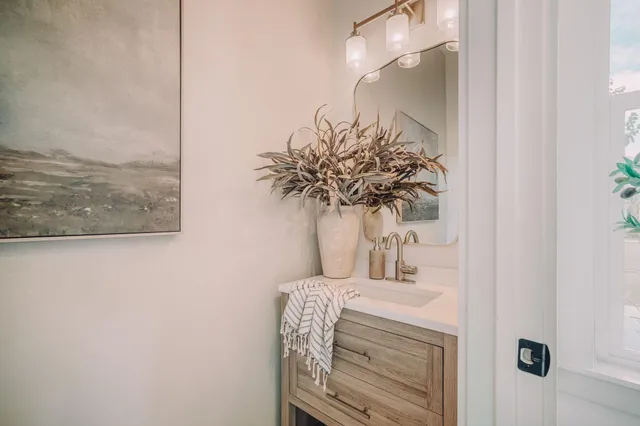 a bathroom with a granite countertop sink a toilet and shower
