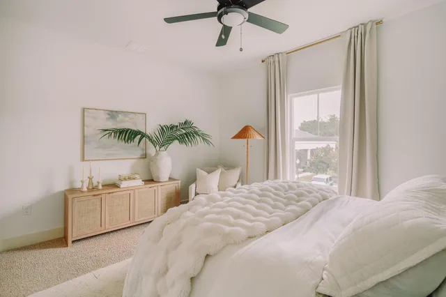 a living room with furniture a flat screen tv and a rug