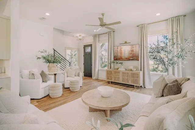 a living room with furniture and a chandelier