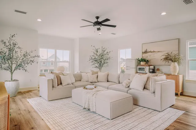 a front view of a house with a yard and trees