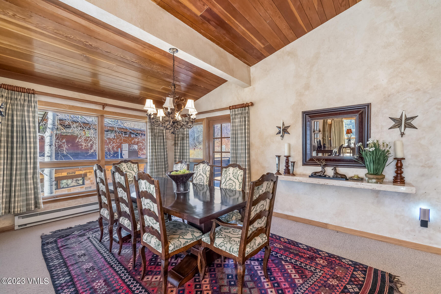 736 Sandy Lane, Unit 1 Vail, CO 81657 - Photo 11 of 36 a view of a dining room with furniture wooden floor and chandelier