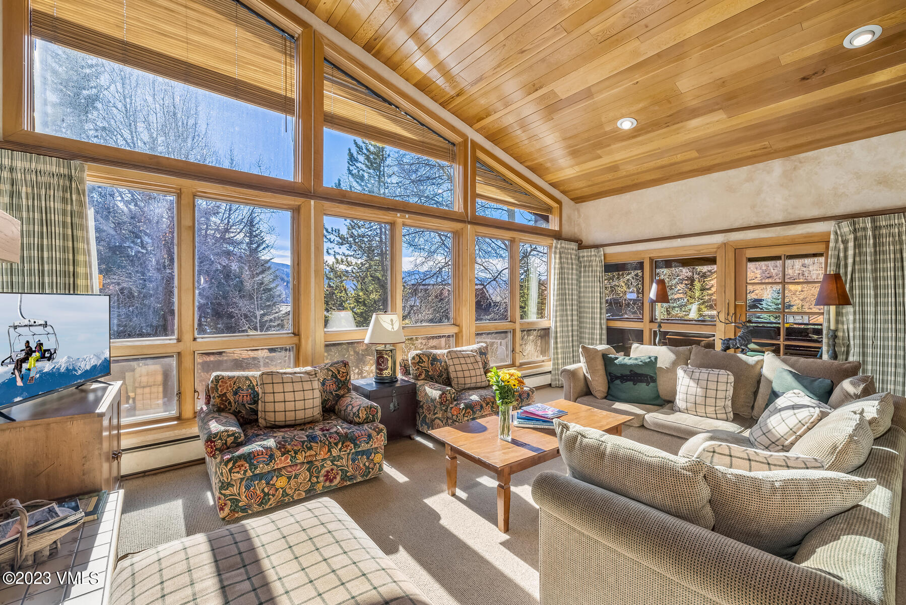 736 Sandy Lane, Unit 1 Vail, CO 81657 - Photo 4 of 36 a living room with furniture and a floor to ceiling window