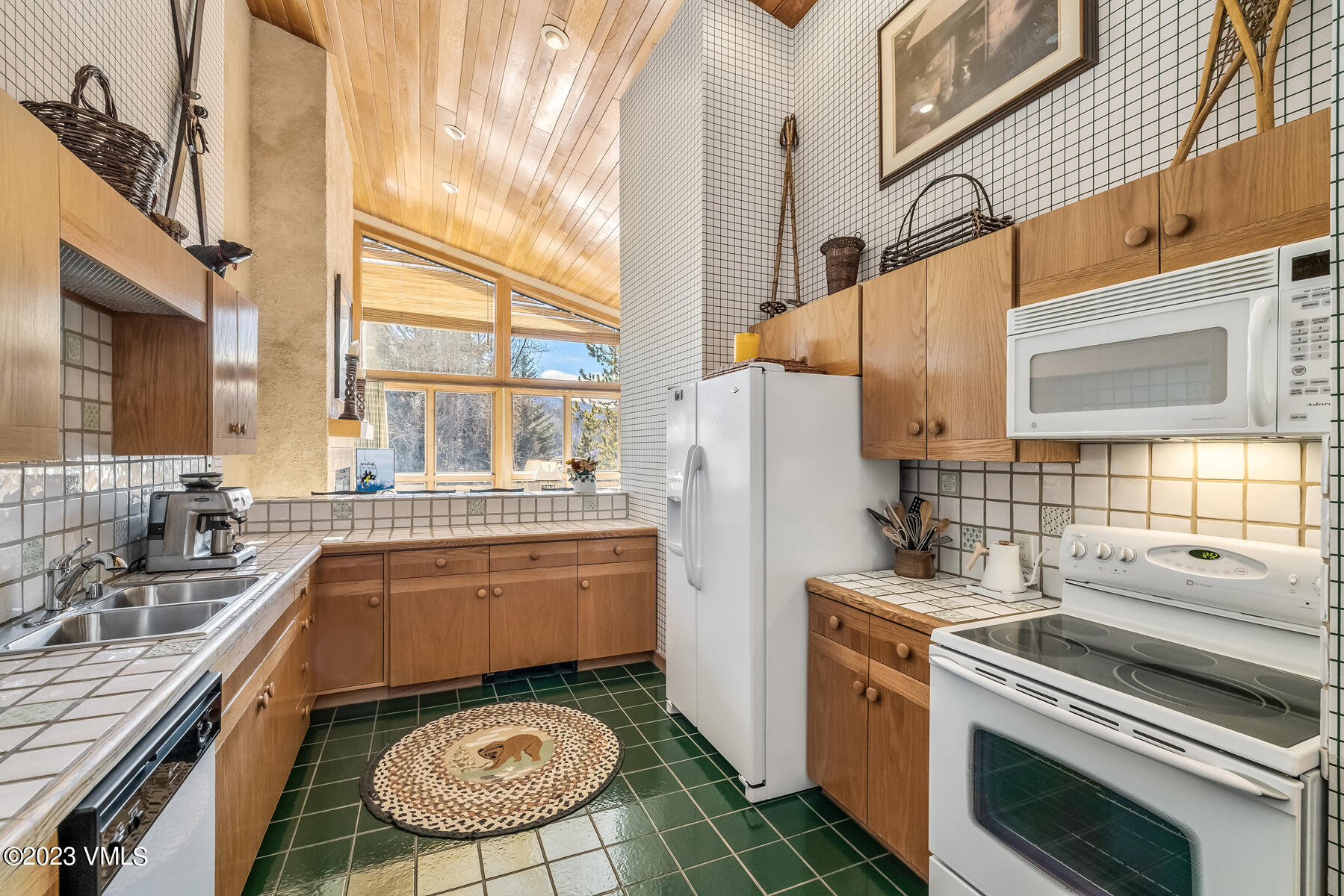 736 Sandy Lane, Unit 1 Vail, CO 81657 - Photo 9 of 36 a kitchen with a stove a sink and a refrigerator
