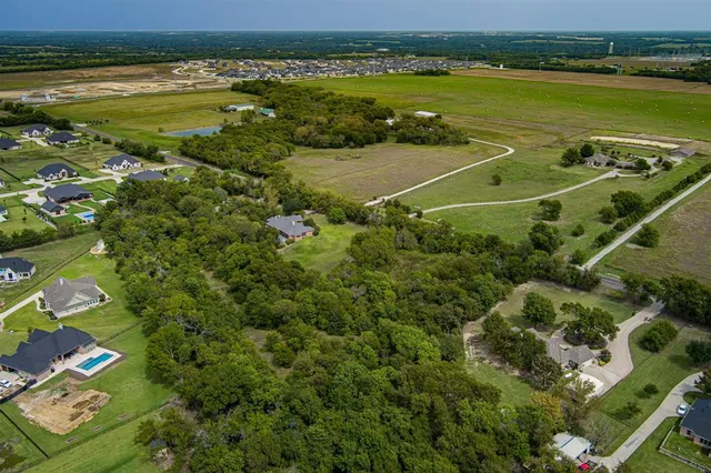 an aerial view of a house with a yard basket ball court and outdoor seating