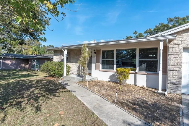 a view of a house with backyard and porch