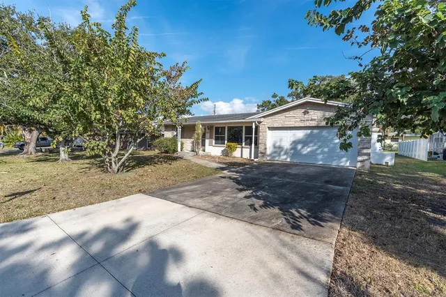 a view of a white house with a yard