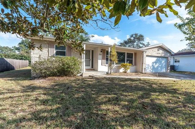 a front view of a house with a yard and a porch