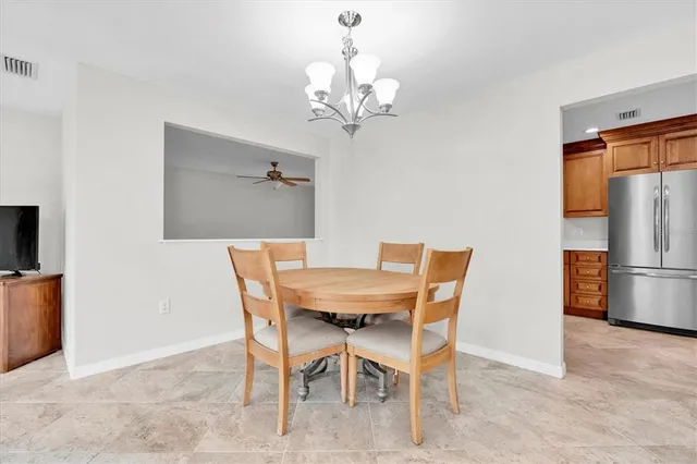 a dining room with furniture and chandelier