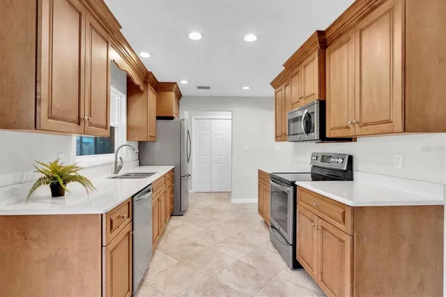 a kitchen with a sink stove and cabinets