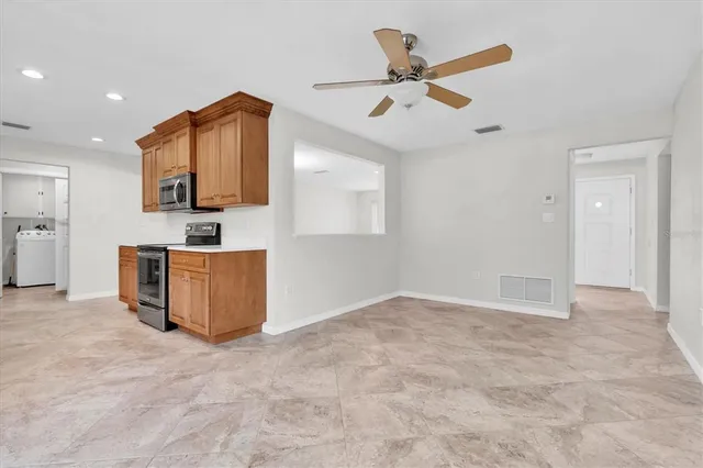 a view of kitchen with microwave and cabinets