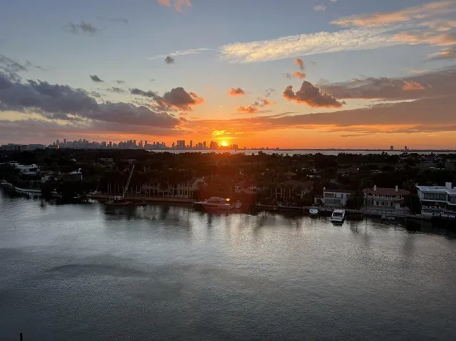 a view of swimming pool with outdoor seating and a lake view