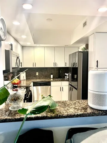 a kitchen with lots of counter top space and appliances