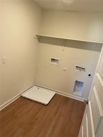 a view of a room with wooden floor