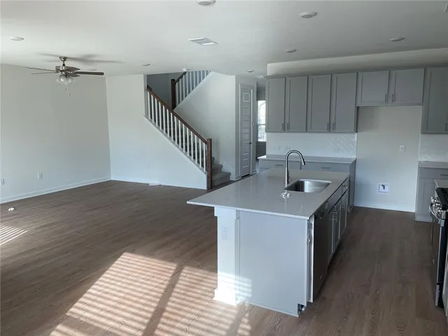a kitchen with a sink and wooden cabinets