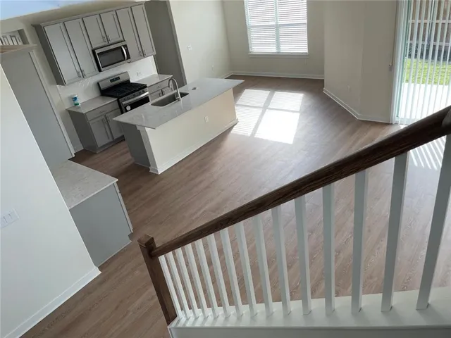 a view of staircase with open kitchen view