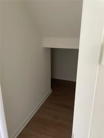 a white toilet sitting in a bathroom next to a wooden bench