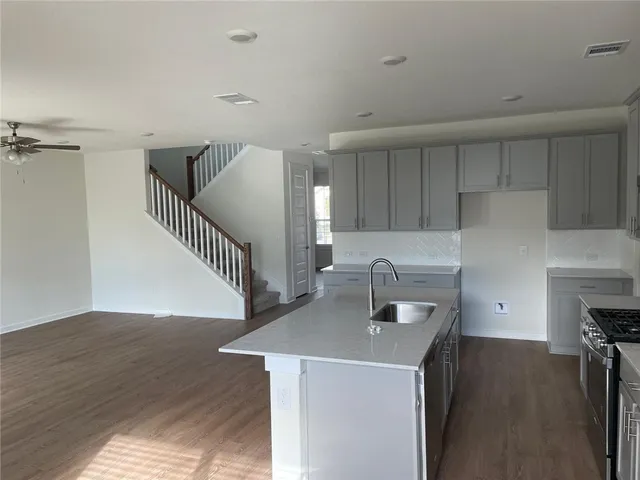 a kitchen with a cabinets and wooden floor