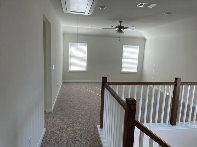 a view of hallway with stairs and a chandelier