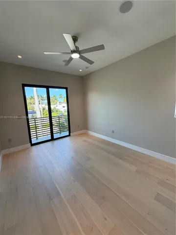 a bathroom with a white tub shower and toilet