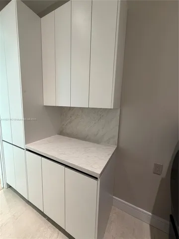 a view of a room with wooden floor and windows