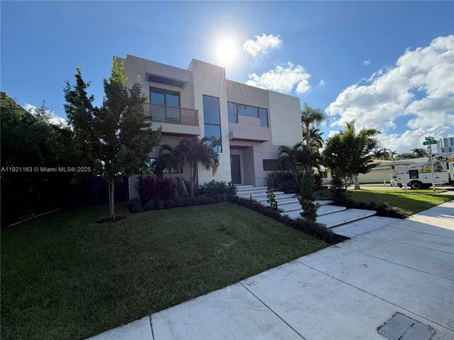a view of a house with a yard and a fountain