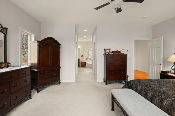a living room with furniture a table and kitchen view