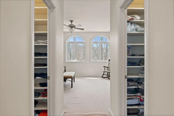 a living room with furniture and large windows