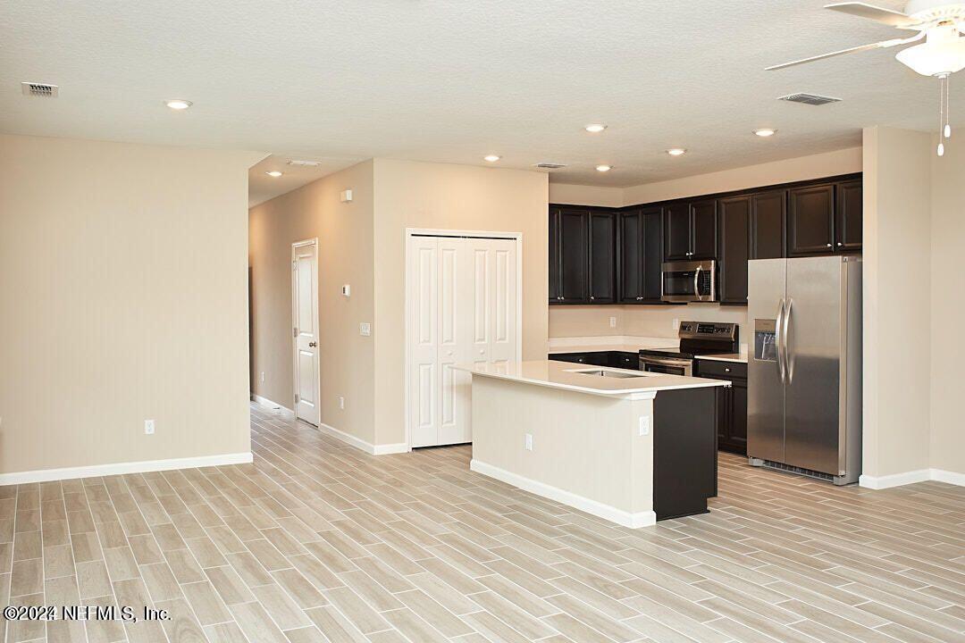 340 Boracay Circle St. Johns, FL 32259 - Photo 11 of 31 a kitchen with granite countertop a refrigerator and a stove top oven