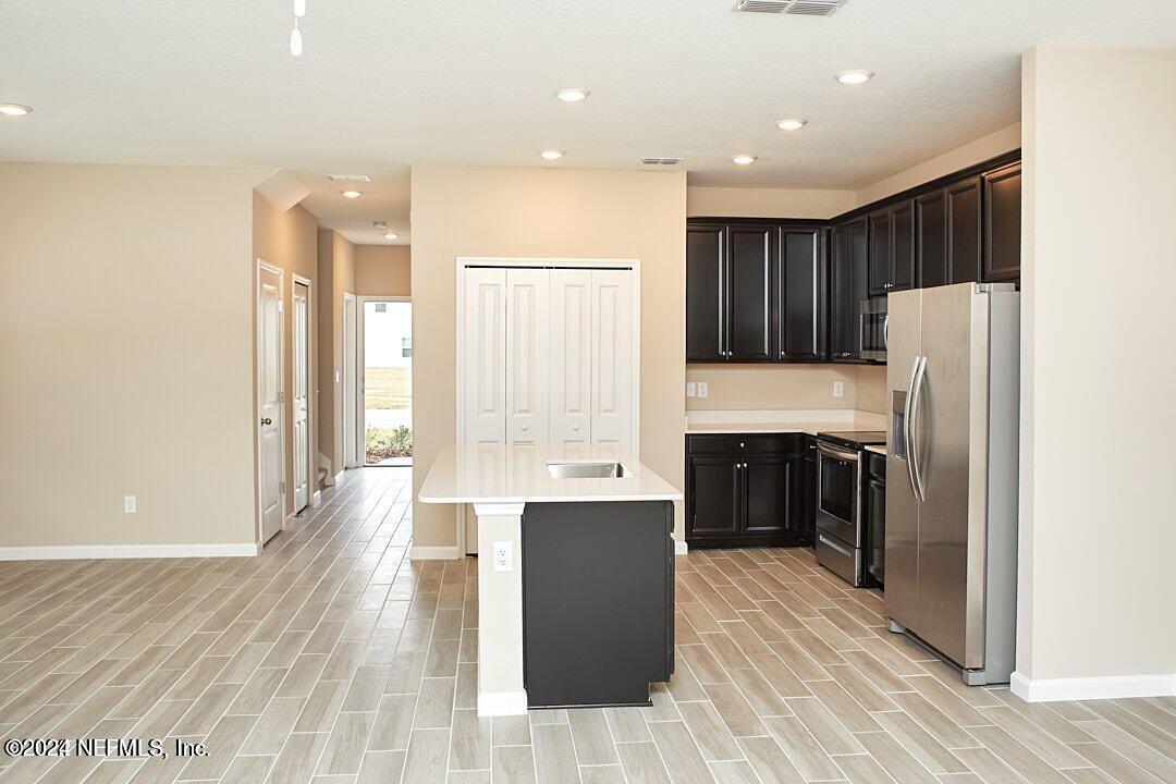 340 Boracay Circle St. Johns, FL 32259 - Photo 12 of 31 a large kitchen with a large counter top a refrigerator and a sink