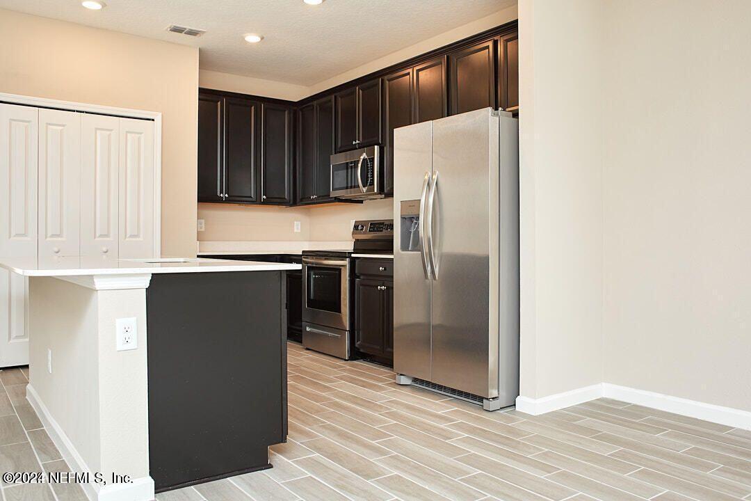 340 Boracay Circle St. Johns, FL 32259 - Photo 13 of 31 a kitchen with stainless steel appliances a refrigerator and a stove