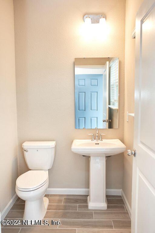 340 Boracay Circle St. Johns, FL 32259 - Photo 18 of 31 a bathroom with a toilet sink and mirror