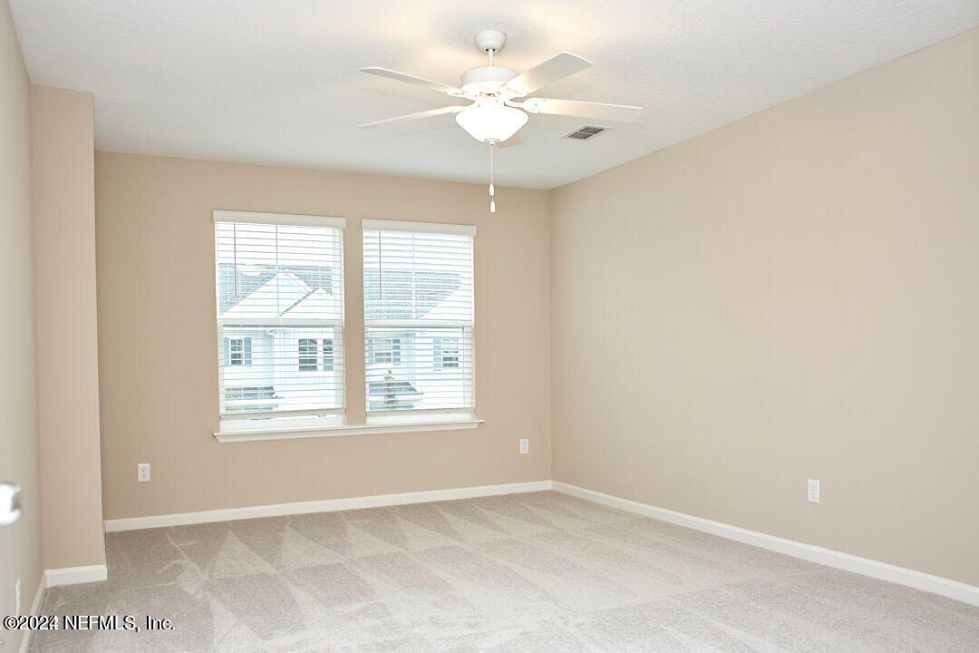 340 Boracay Circle St. Johns, FL 32259 - Photo 20 of 31 an empty room with windows and ceiling fan