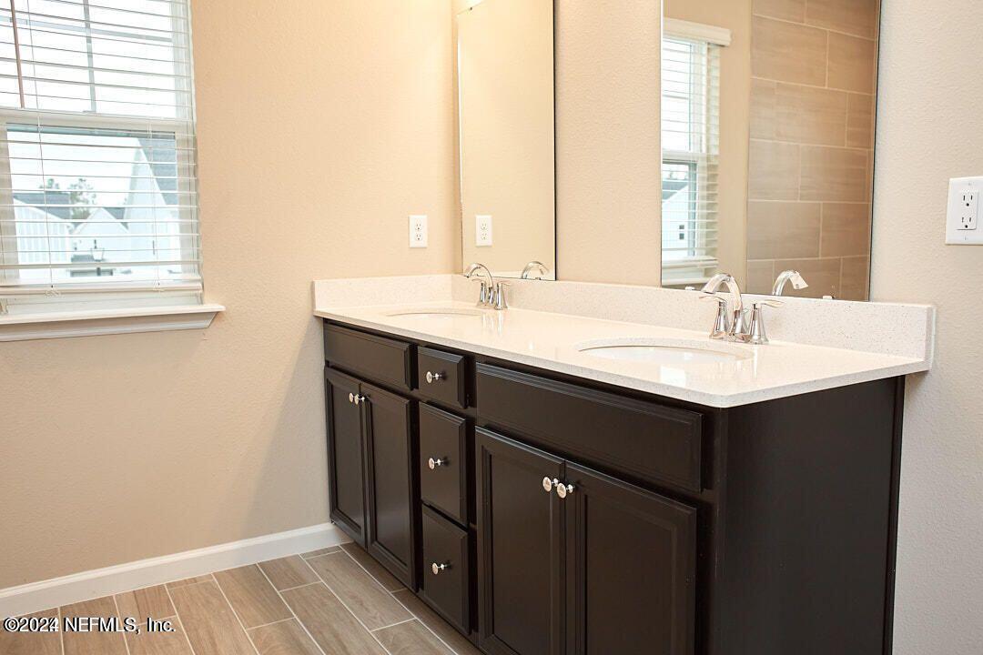 340 Boracay Circle St. Johns, FL 32259 - Photo 22 of 31 a bathroom with a sink and a mirror