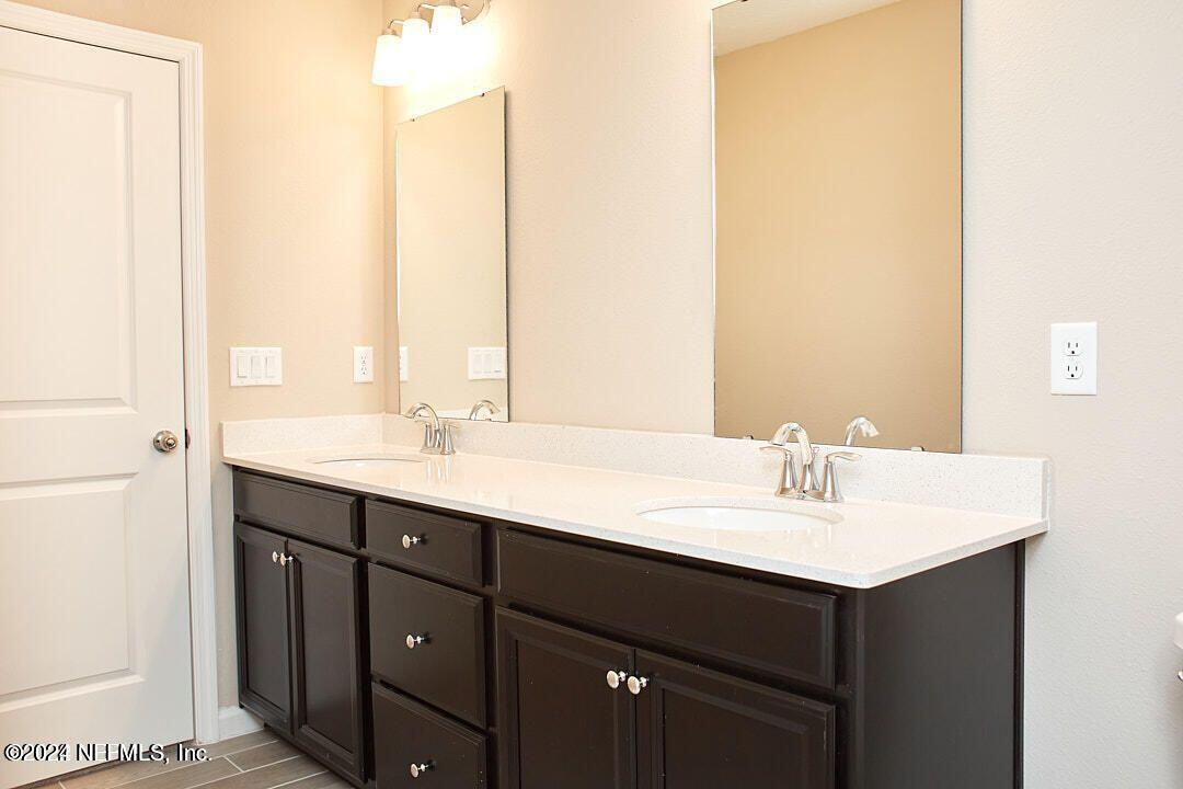 340 Boracay Circle St. Johns, FL 32259 - Photo 25 of 31 a bathroom with a sink and a mirror
