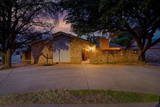 a yellow house with tree in front of it