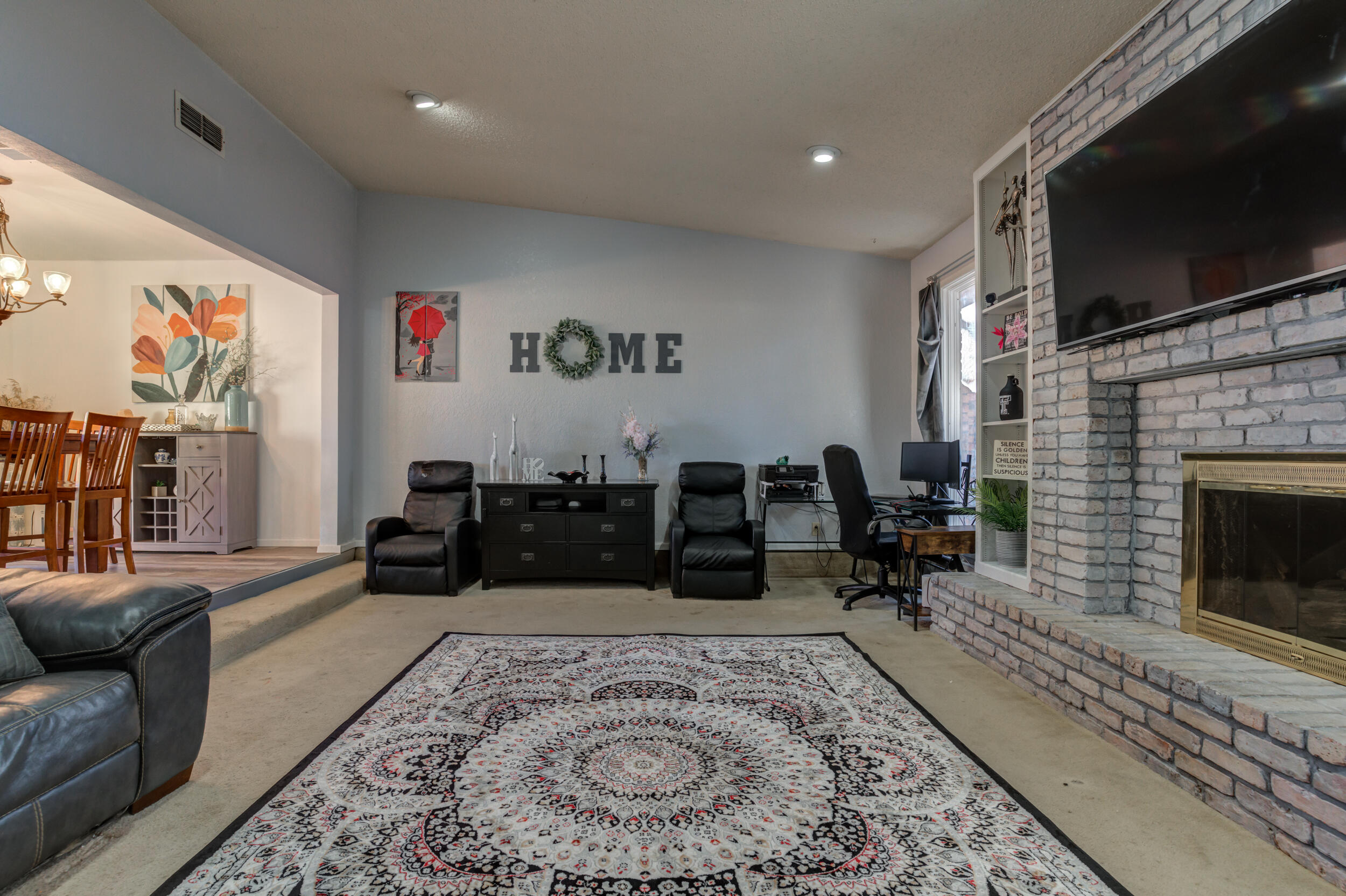 4524 79th Street Lubbock, TX 79424 - Photo 14 of 45 a living room with furniture or couch and a flat screen tv
