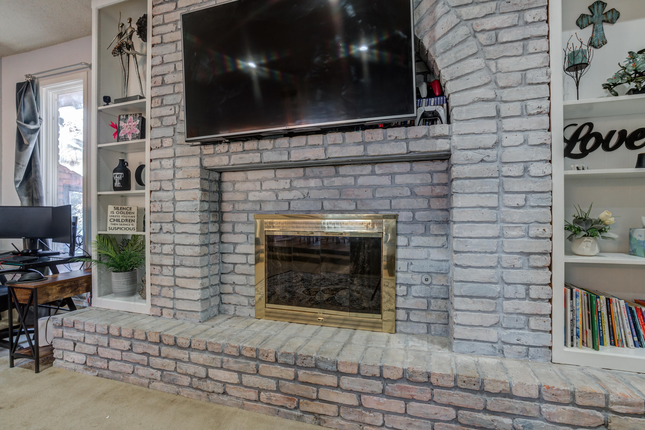 4524 79th Street Lubbock, TX 79424 - Photo 15 of 45 a living room with a fireplace and a flat screen tv