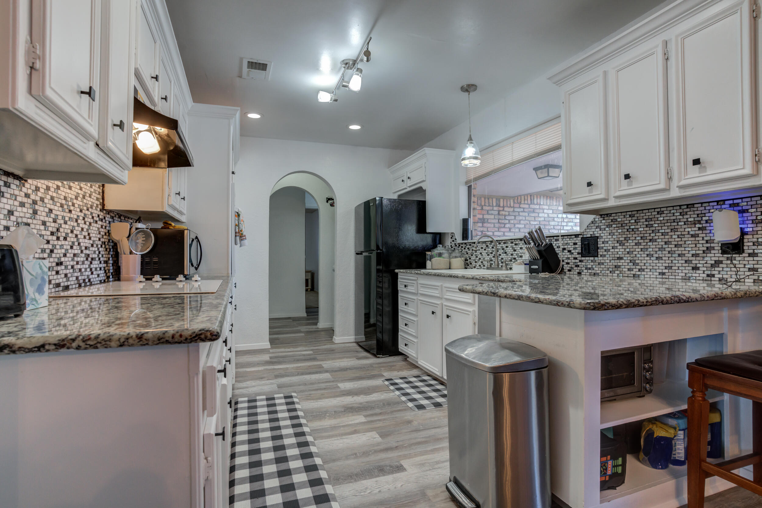 4524 79th Street Lubbock, TX 79424 - Photo 16 of 45 a kitchen with stainless steel appliances granite countertop a sink and cabinets
