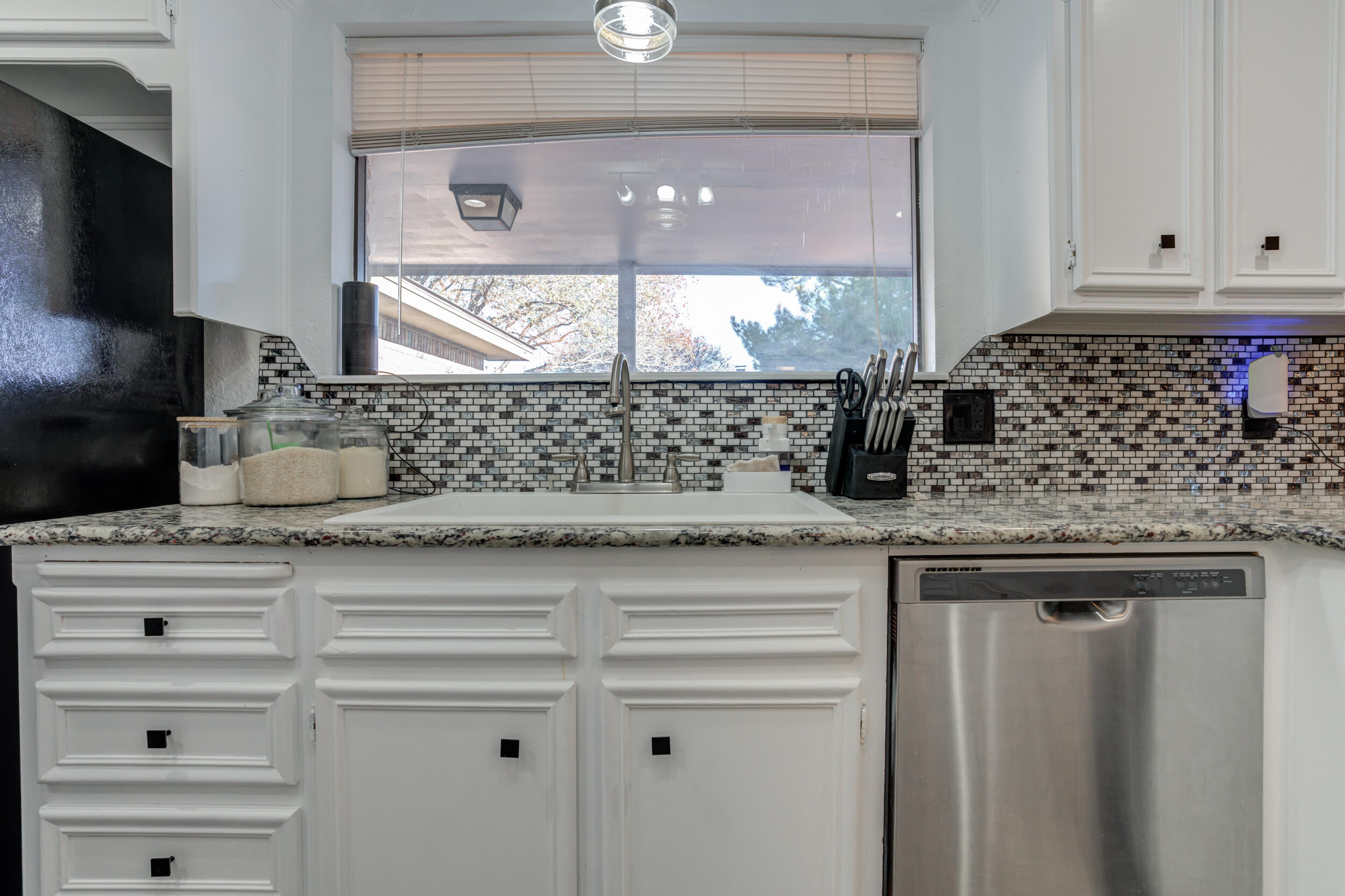 4524 79th Street Lubbock, TX 79424 - Photo 19 of 45 a kitchen with stainless steel appliances granite countertop a sink and a white cabinets