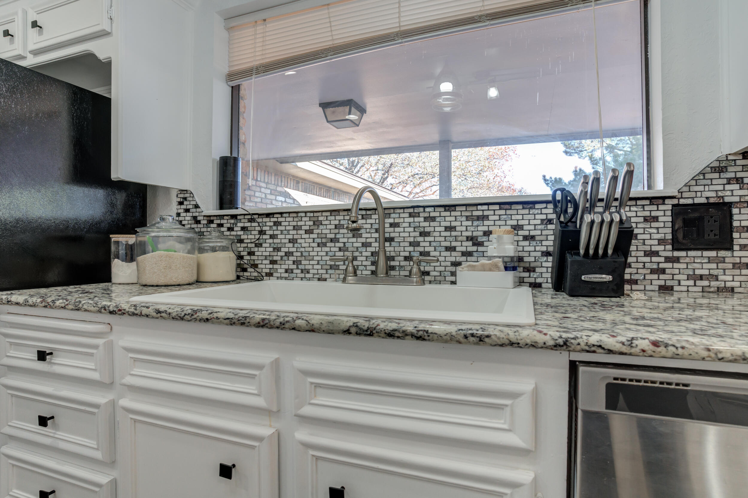 4524 79th Street Lubbock, TX 79424 - Photo 20 of 45 a kitchen with granite countertop a sink and a stove
