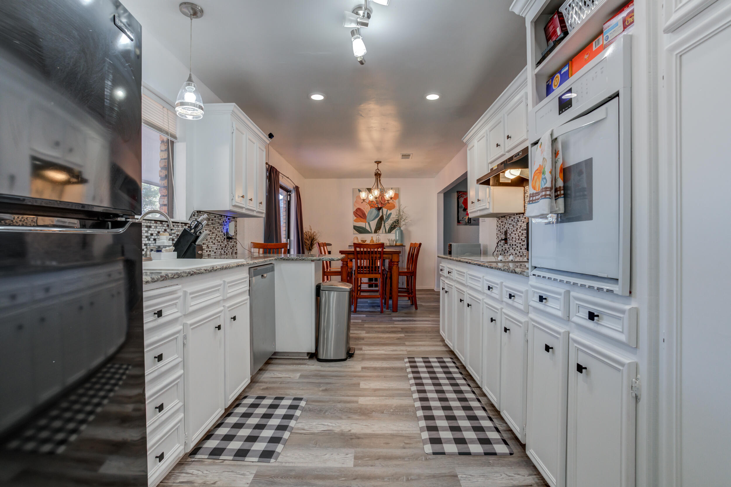 4524 79th Street Lubbock, TX 79424 - Photo 21 of 45 a kitchen with stainless steel appliances kitchen island granite countertop a sink and cabinets