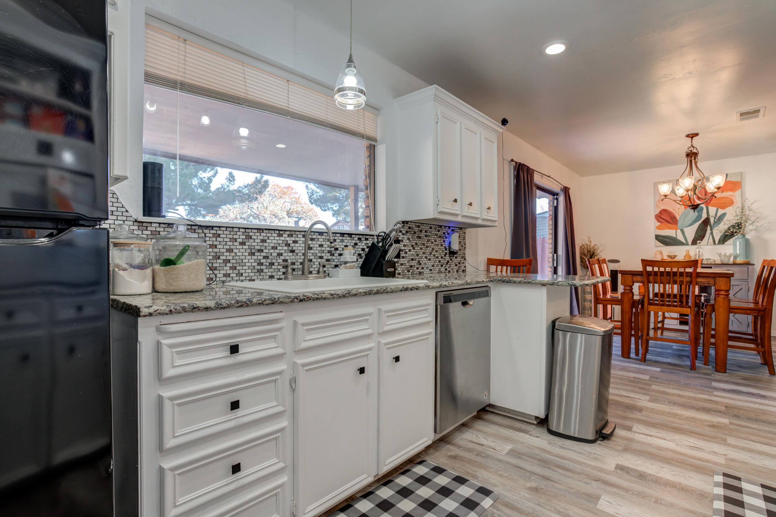 4524 79th Street Lubbock, TX 79424 - Photo 22 of 45 a kitchen with stainless steel appliances kitchen island granite countertop a stove a sink and a refrigerator