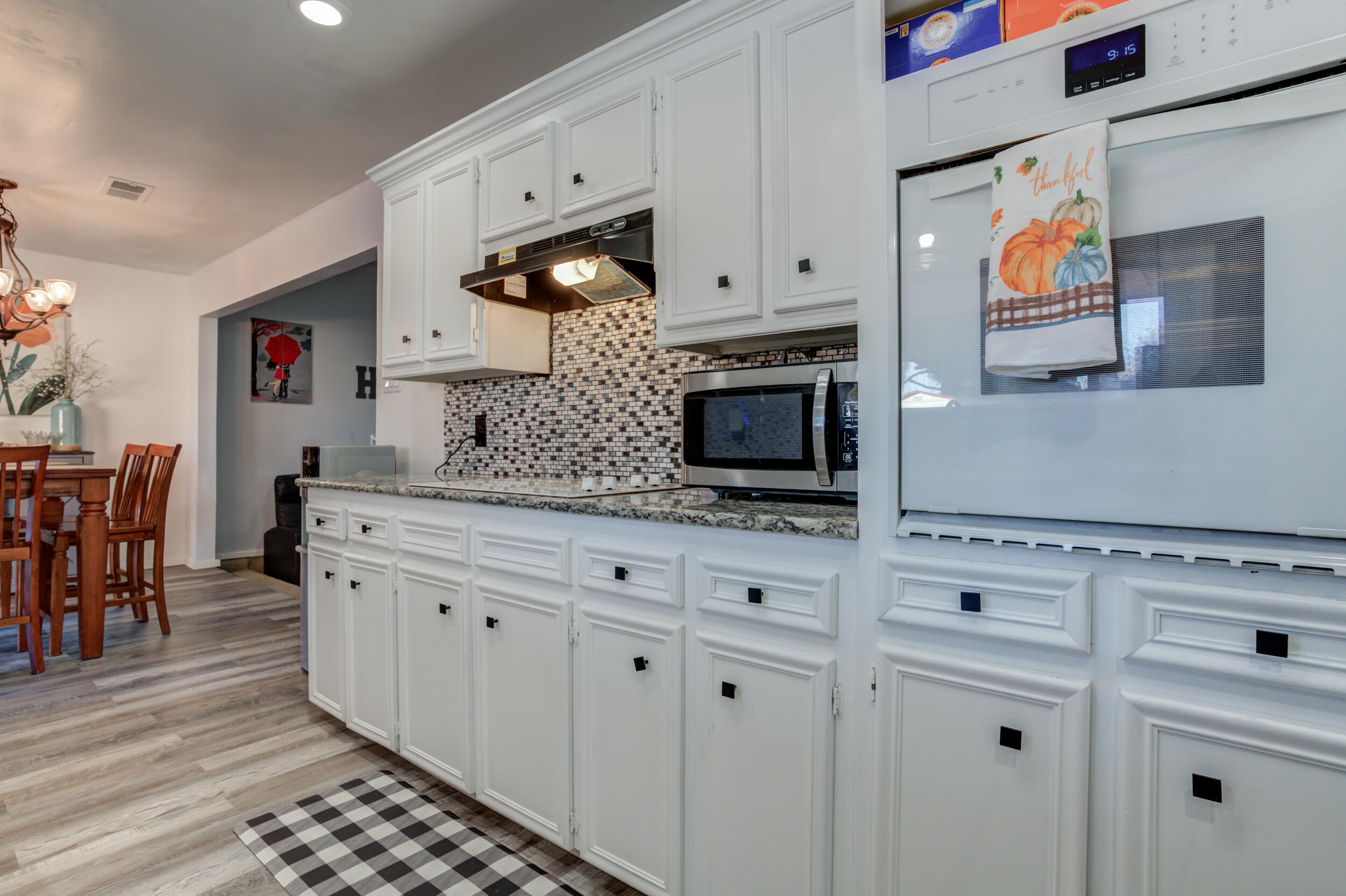 4524 79th Street Lubbock, TX 79424 - Photo 23 of 45 a kitchen with stainless steel appliances white cabinets and a refrigerator