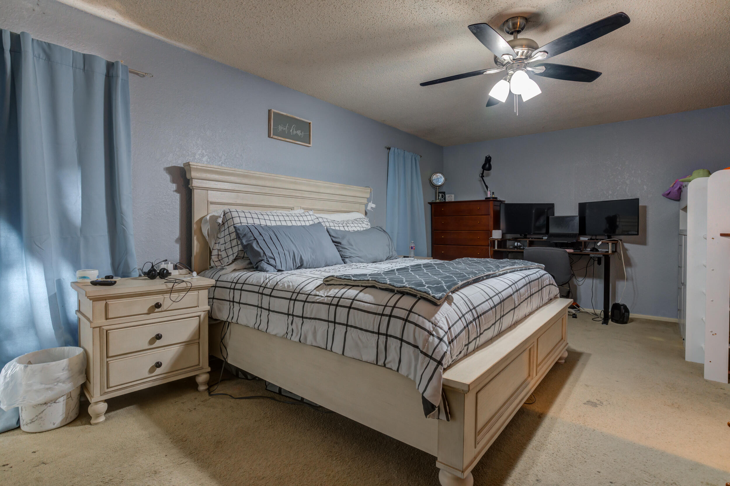 4524 79th Street Lubbock, TX 79424 - Photo 29 of 45 a bed room with a bed and a chandelier