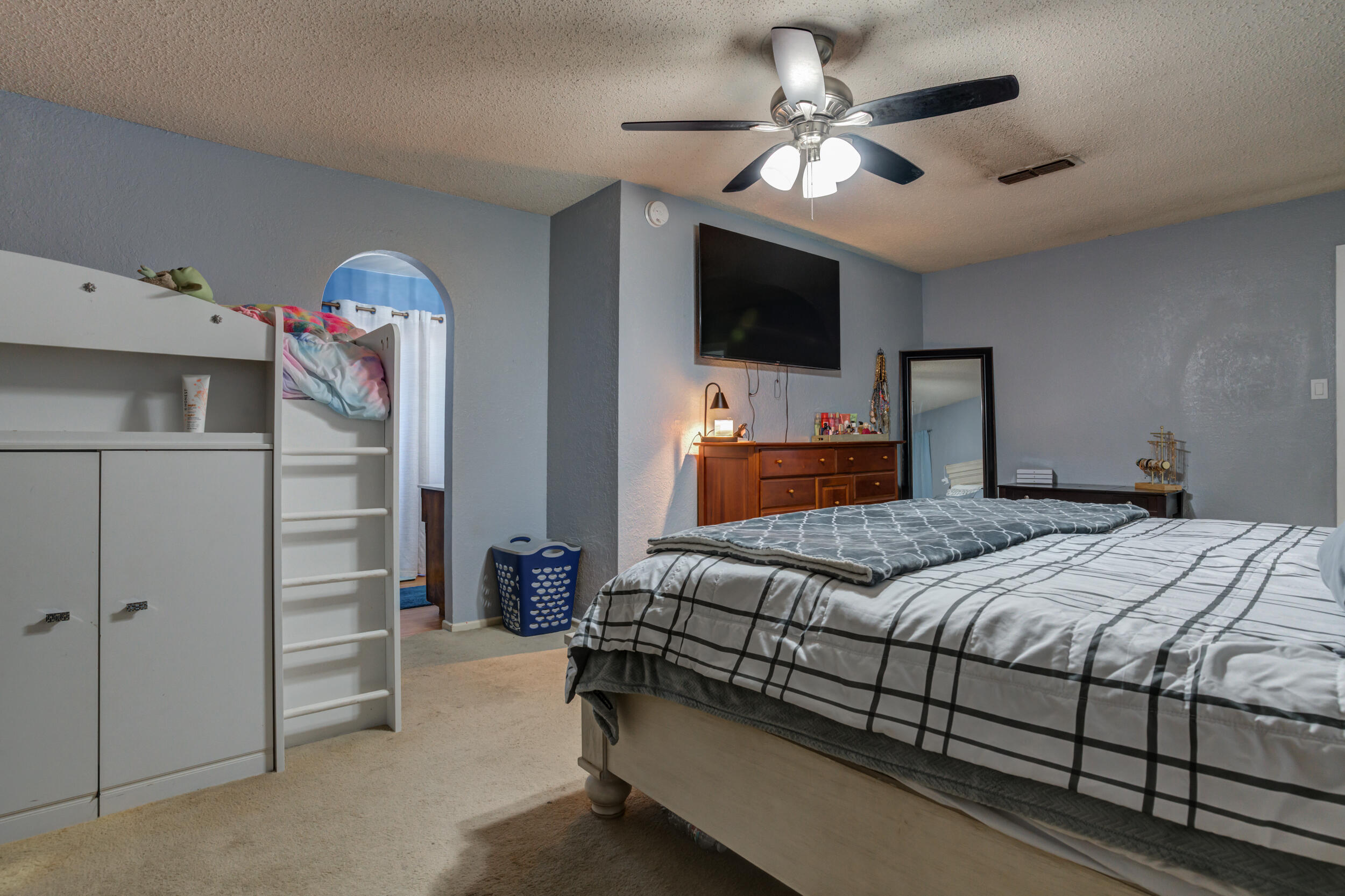 4524 79th Street Lubbock, TX 79424 - Photo 31 of 45 a bedroom with a bed and a flat screen tv