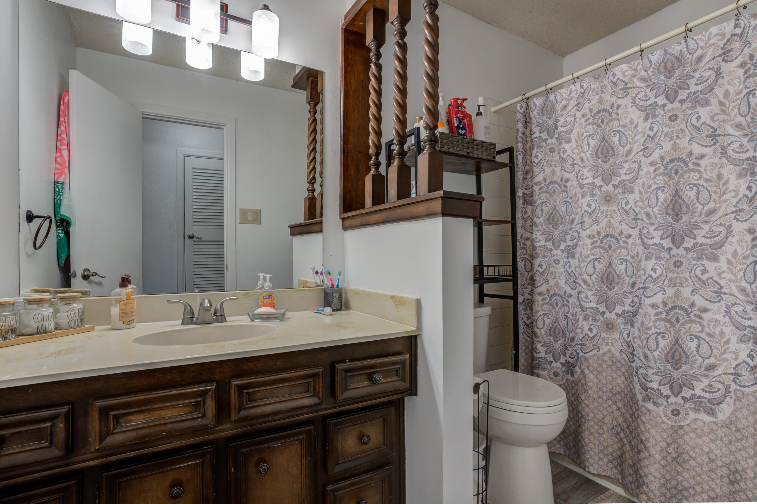 4524 79th Street Lubbock, TX 79424 - Photo 38 of 45 a bathroom with a granite countertop sink toilet and mirror